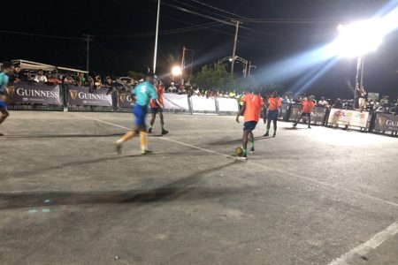 A scene from the Ballers and Dartmouth (orange) clash in the Guinness ‘Greatest of the Streets’ Essequibo edition