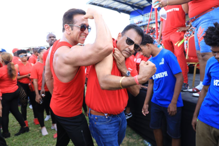 Rural Development and Local Government Minister Faris Al-Rawi, left, and Works and Transport Minister Rohan Sinanan show off their muscles during the PNM’s Sports and Family Day at Skinner Park, San Fernando, yesterday.KRISTIAN DE SILVA