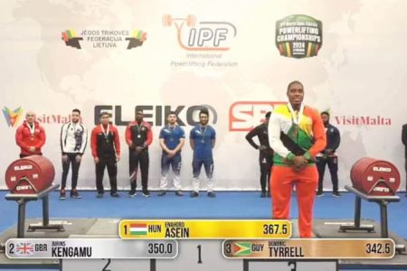 aGuyana’s Dominic Tyrell stands on the podium after clinching a bronze medal at the World Classic Open Powerlifting Championships in Lithuania. He also
finished sixth overall in the 83kg
category among a field of 26 athletes