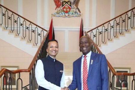Prime Minister Dr Keith Rowley, right, greets Naveen Jindal, chairman of Jindal Steel and Power Ltd, at the Diplomatic Centre on Monday
