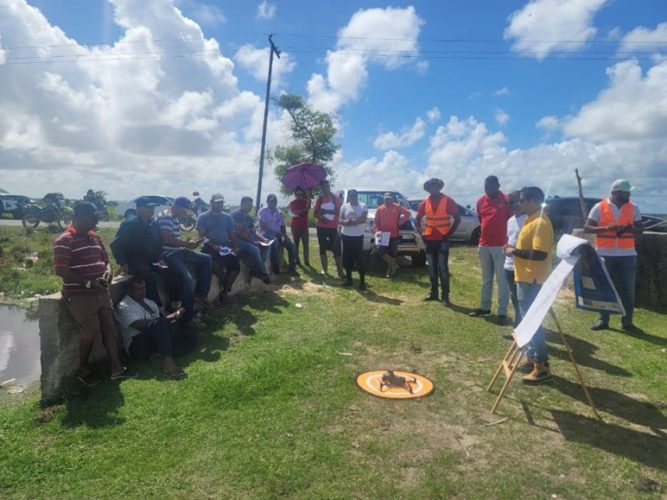 The GRBD team training a few farmers in how to use a drone
