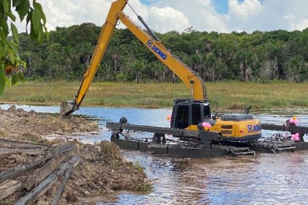 The excavator at work clearing the canals