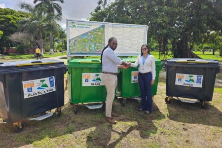 Officer-in-Charge, UNDP Guyana, Nadira Balram (right), handing over the bins to Commissioner, Protected Areas Commission, Jason Fraser 
