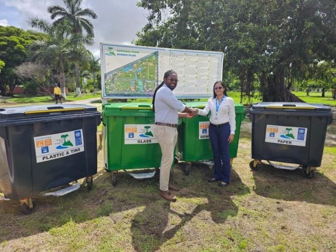 Officer-in-Charge, UNDP Guyana, Nadira Balram (right), handing over the bins to Commissioner, Protected Areas Commission, Jason Fraser 