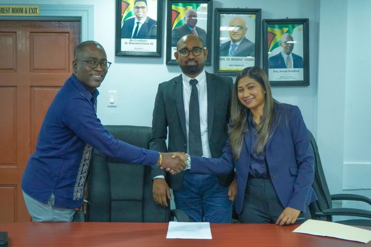 GTU Head Mark Lyte (left) shakes hands with Ministry of Education Permanent Secretary Shannielle Hoosein-Outar while Chief Labour Officer Dhaneshwar Deonarine looks on. (Ministry of Education photo)