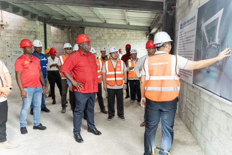 Prime Minister Mark Phillips (centre) being given a briefing on the hospital  (Office of the Prime Minister photo)