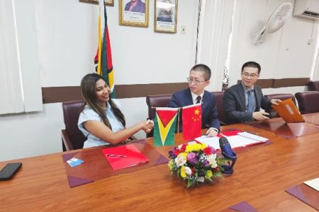 Ministry of Education Permanent Secretary Shannielle Hoosien-Outar (left) and Deputy Chief of Mission of the Chinese Embassy, Counselor Huang Rui, congratulating each other on the signing of the MoU to initiate the 2024 Guyana-China Friendship Youth Leadership Development Competition. 
