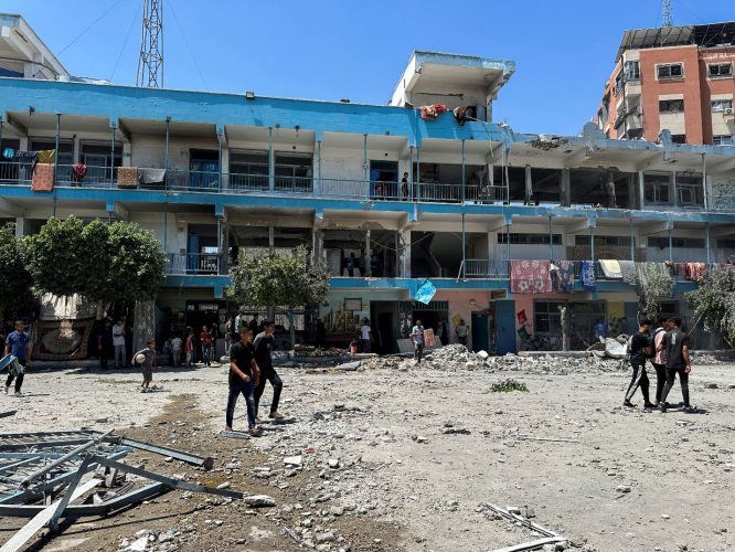 Palestinians inspect the site of an Israeli strike on a UNRWA school sheltering displaced people, amid the Israel-Hamas conflict, in Nuseirat refugee camp in the central Gaza Strip, June 6, 2024. REUTERS/Doaa Rouqa