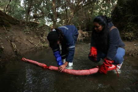 Members of Matter of Trust Chile prepare to place a tube-like device made from human hair as part of 'Petropelo', a system that utilizes hair's natural absorbent qualities to clean waterways of oils, heavy metals, and even bacteria, in Laguna Verde area, Chile May 28, 2024. REUTERS/Ivan Alvarado