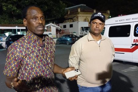 Minister of National Security Fitzgerald Hinds (left) and Senior Superintendent of the Homicide Bureau of Investigations Rishi Singh address the media at the Port-of-Spain General Hospital early Monday morning.