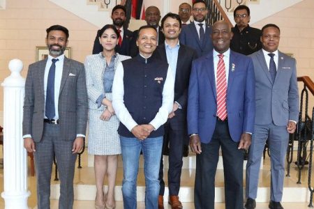 High-powered visit: Prime Minister Dr Keith Rowley, second from right, and Cabinet ministers take a group shot with Naveen Jindal, third from left, chairman of Jindal Steel and Power Ltd, and members of his team at the Diplomatic Centre, Port of Spain, on Monday.