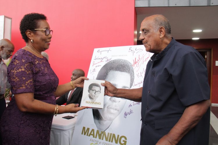 Hazel Manning presents Prof Ken Julien with a copy of Manning: Faith and Vision at the book launch at NAPA, Port-of-Spain, on Sunday.