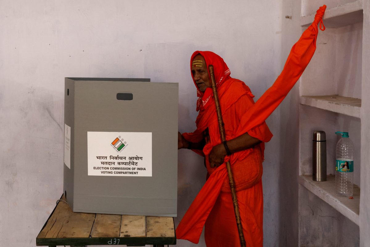A Sadhu or a Hindu holy man casts his vote inside a polling station during the seventh and last phase of India’s general election in Varanasi, India, June 1, 2024. REUTERS/Priyanshu Singh