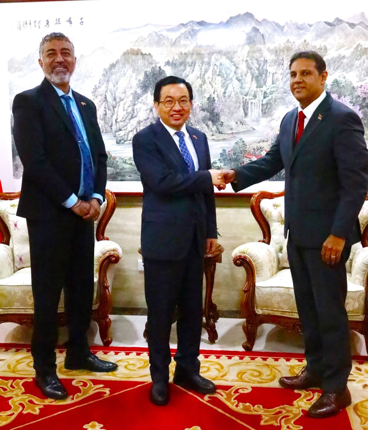 The People’s Republic of China’s ambassador Fang Qiu, greets CMO Dr Roshan Parasam, during the China-Trinidad cardiovascular medicine forum, at the Embassy of the People’s Republic of China, Long Circular Road, Maraval, yesterday. At left is, Ministry of Health Permanent Secretary Asif Ali.