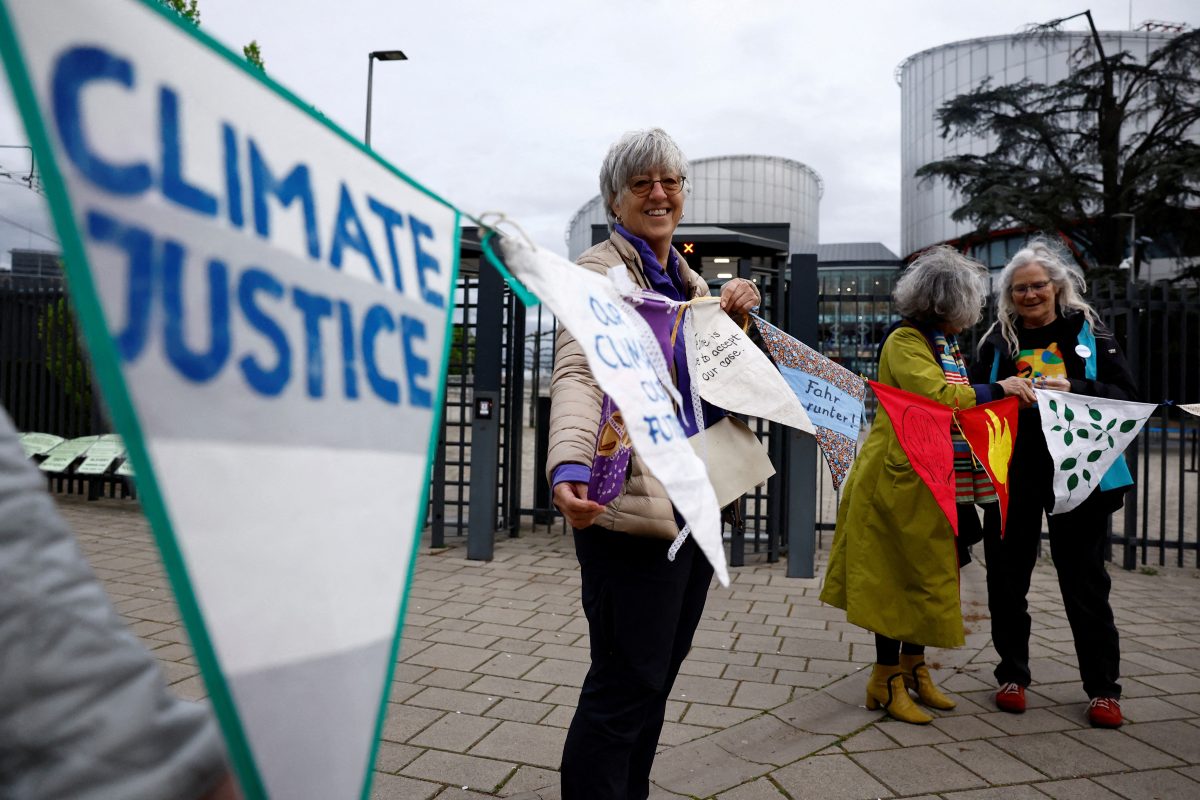 FILE PHOTO: Supporters and members of the association Senior Women for Climate Protection hold banners as they arrive for the ruling in the climate case Verein KlimaSeniorinnen Schweiz and Others v. Switzerland, at the European Court of Human Rights (ECHR) in Strasbourg, France, April 9, 2024. The slogan reads “Climate justice”. REUTERS/Christian Hartmann/File Photo