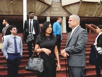 OUTSIDE COURT: Auditor General Jaiwantie Ramdass (centre) speaks to her lead attorney Anand Ramlogan, SC, outside the Hall of Justice in Port of Spain yesterday.
