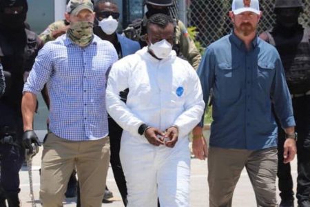 Germine Joly, better known as “Yonyon” (centre) was transferred aboard a special Federal Bureau of Investigation flight on Tuesday, May 3 to the U.S. following a request from the U.S. on April 22. HAITI NATIONAL POLICE