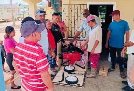 Prime Ministerial Representative for Region Two, Arnold Adams, handing over the tillers to farmers in the Akawini community