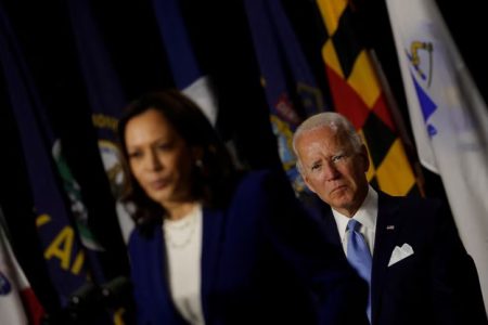 Democratic U.S. vice presidential candidate Kamala Harris listens as Democratic U.S.presidential candidate Joe Biden calls for the mandatory wearing of protective face masks as they face reporters after receiving a briefing on the coronavirus disease (COVID-19) pandemic from public health officials during a campaign event in Wilmington, Delaware, U.S., August 13, 2020.