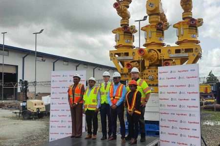 ExxonMobil’s Country President Alistair Routledge flanked by representatives of the Environmental Protection Agency and the  Civil Defence Commission in front of the capping stack, yesterday at GYSBI.  