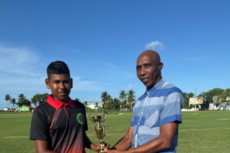 Romario Ramdehol (left) accepts his man-of-the-match prize from Shaun Massiah
