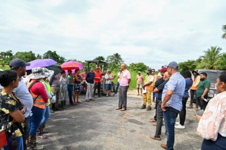 Minister of Public Works, Juan Edghill (centre) engaging residents of Bendorff on the road project (DPI photo)
