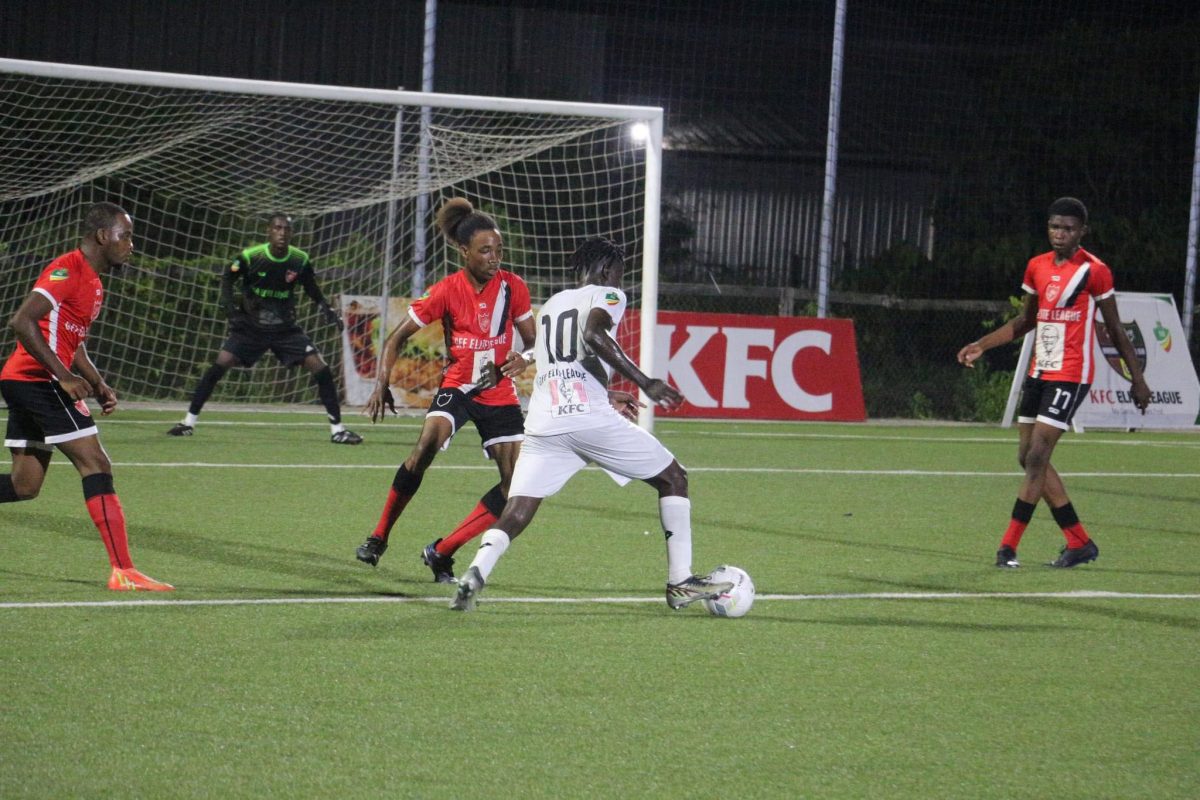 Bevney McGarrell (no.10) of Santos on the attack against Buxton United