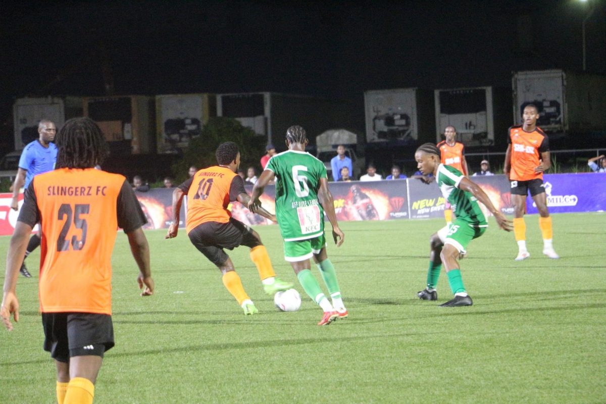 Kemar Beckford (no.10) trying to evade the pursuits of two Den Amstel players
