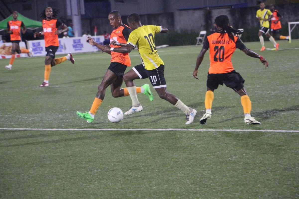 Tyreek Cummings (yellow) of Buxton United tries to skip past Leo Lovell (left) and Dominique Babb of Slingerz FC