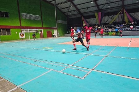 Daniel Wilson (yellow) of Western Tigers is in the process of attempting a long ball against Den Amstel in the KFC Elite League.