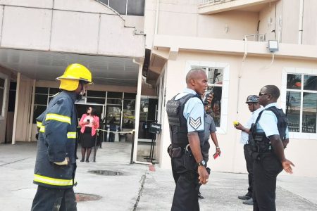 Police officers and fire fighters at the building
