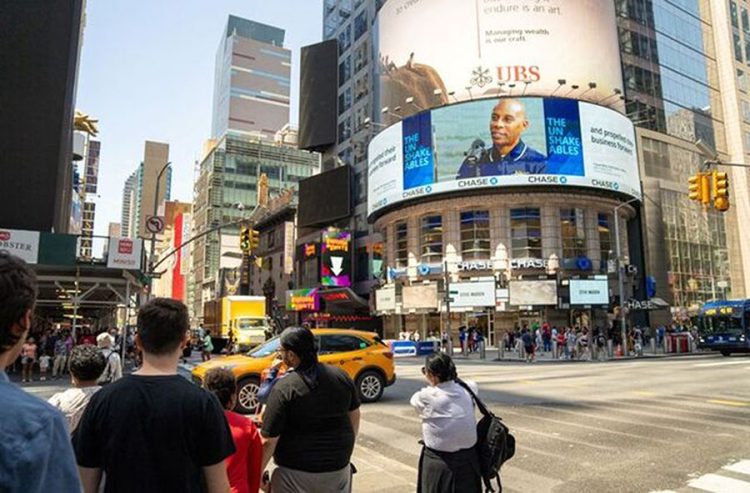 People stand near the blacked-out digital billboards at Times Square following a global IT outage, in New York City, U.S. July 19, 2024. REUTERS/David 'Dee' Delgado 