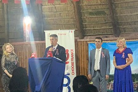 French Ambassador to Guyana and Suriname,  Nicolas de Bouillane de Lacoste presenting at the occasion of the French National Day, alongside Chargé d’Affaires & Head of the French Diplomatic Bureau in Guyana Jean-Jacques Forté (second from right) and the Ambassador’s spouse Maya de Lacoste (right)