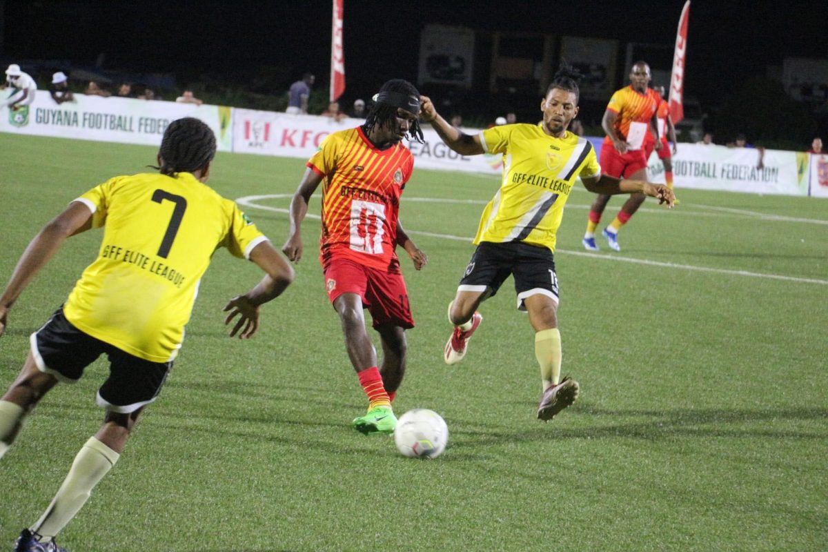 GDF’s Kelsey Benjamin (centre) goes on the attack amidst the close attention of two Buxton United players. 
