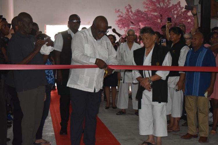 Prime Minister Brigadier (Ret’d) Mark Phillips cuts the ribbon to declare  open the
Dr. Frank Woon-A-Tai Budokan at Liliendaal, in the presence of Dr. Woon-A-Tai.
(Zaheer Mohamed photo)