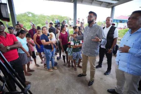 President Mohamed Irfaan Ali addressing fisherfolk and residents during a meeting in Mon Repos (DPI photo)