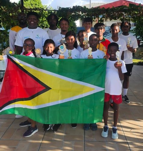 Team Guyana posing with their respective individual and doubles trophies following the conclusion of the SAGICOR Junior Tennis Championship in Trinidad and Tobago