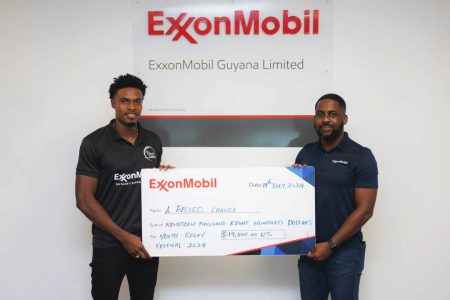 Arinze Chance (left), founder of ‘A Record Chance Inc’
(ARC) receives the sponsorship cheque from ExxonMobil’s Ryan Hoppie.