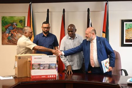 The handing over of the equipment. From right are Gerardo Noto, UNDP Resident Representative for Guyana and Suriname,  Minister of Home Affairs, Robeson Benn, Permanent Secretary  Andre Ally, and Deputy Commissioner “Administration” (ag)  Ravindradat Budhram. 