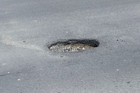 The pothole at the centre of the road in the vicinity of Mon Repos
