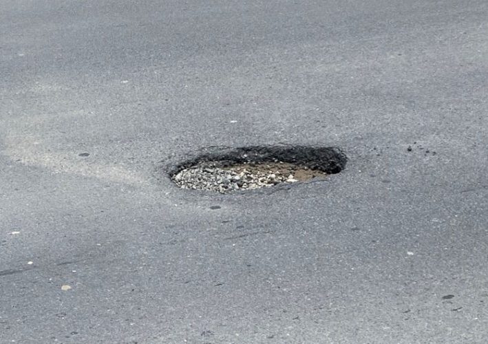 The pothole at the centre of the road in the vicinity of Mon Repos
