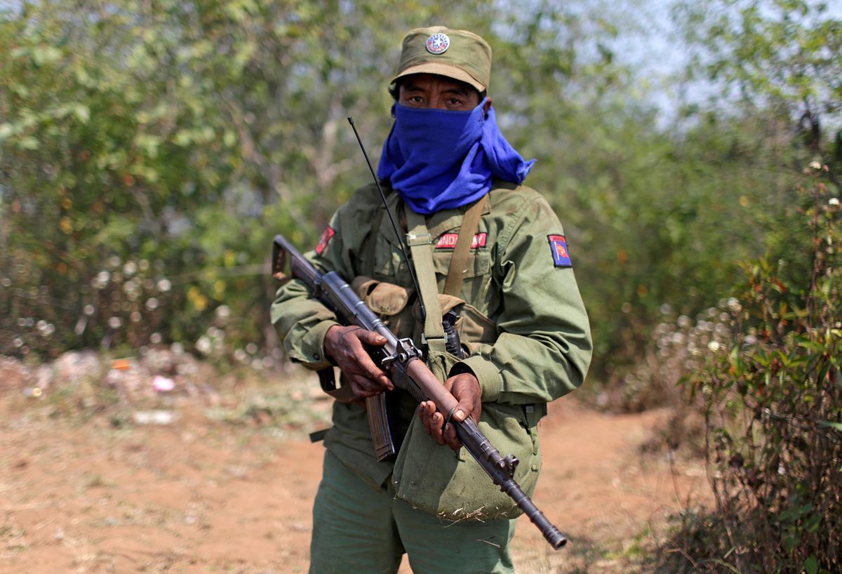 FILE PHOTO: A rebel soldier of the Myanmar National Democratic Alliance Army (MNDAA) holds his rifle as he guards near a military base in Kokang region March 11, 2015. REUTERS/Stringer/File Photo