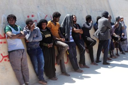 FILE - Migrants are seen after they were picked up by a coast guard patrol after a boat accident off the Libyan coast in Qarabulli town, east of the capital Tripoli, Libya, June 2, 2019.