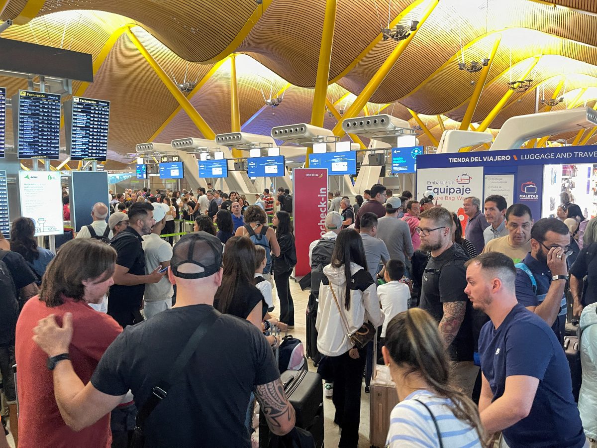 Passengers wait at Barajas Airport, as Spanish airport operator Aena on Friday reported a computer systems "incident" at all Spanish airports which may cause flight delays, in Madrid, Spain July 19, 2024. REUTERS/Elena Rodriguez