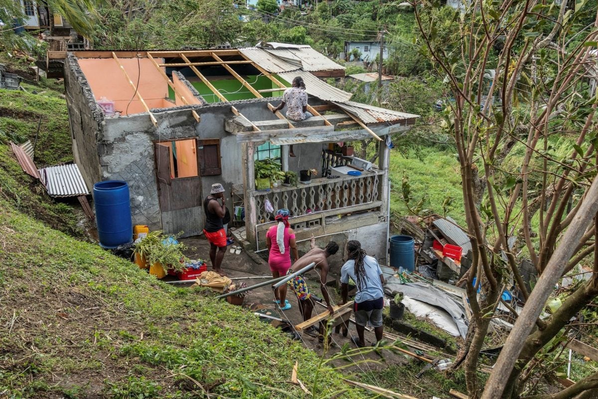 Family members begin to repair their home damaged in the passing of Hurricane Beryl in Ottley Hall, St Vincent and the Grenadines. (AP photo)