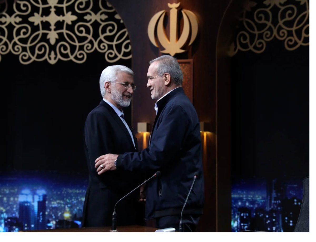 In this photo made available by Iranian state-run TV, IRIB, Iranian presidential candidate Saeed Jalili, left, a hard-line former nuclear negotiator, and reformist candidate Masoud Pezeshkian greet one another at the conclusion of a debate at the TV studio in Tehran, Iran, on June 1, 2024.Morteza Fakhri Nezhad/AP / IRIB