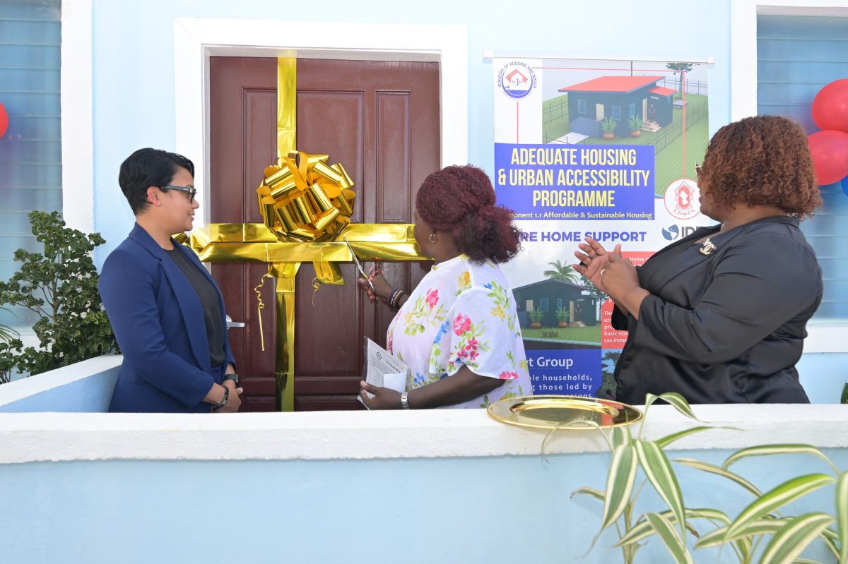 One of the recipients cutting the ribbon to her new home (CH&PA photo)