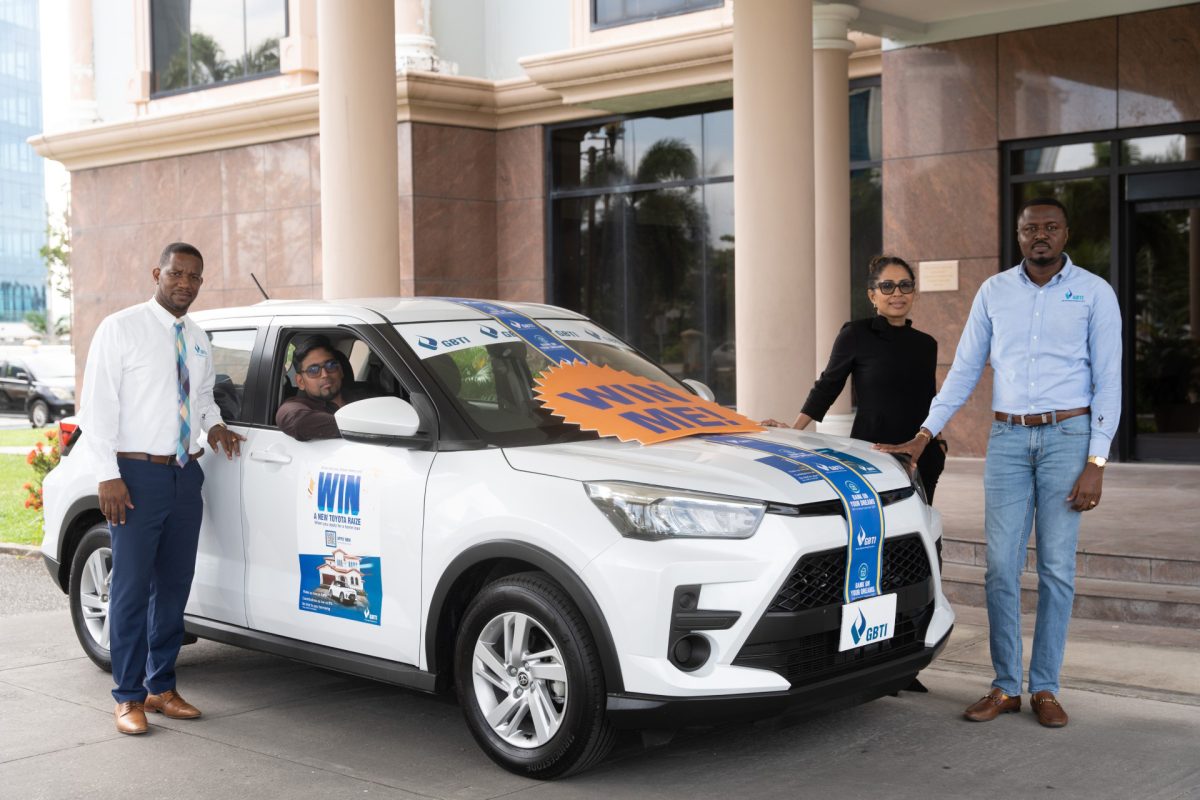 At left is Rajendra Kellawan- GBTI drive home 2023 winner, second from left: Pernell Cummings – GBTI Marketing Manager, at right is Nadia Sagar – GBTI General Counsel, second from right is Akeem Morris- GBTI Marketing and Communications Officer. 