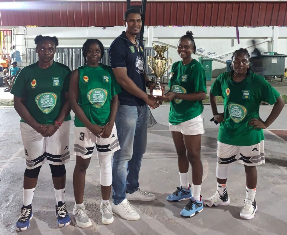 The victorious Kwakwani Untouchables unit receiving their accolade from GBF Vice-President Jermaine Slater after besting Lady Trojans in the final