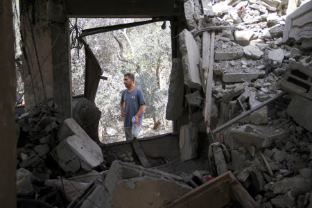 A Palestinian man stands at the site of an Israeli strike on a house, amid the Israel-Hamas conflict, in Beit Lahia in the northern Gaza Strip, August 22, 2024.